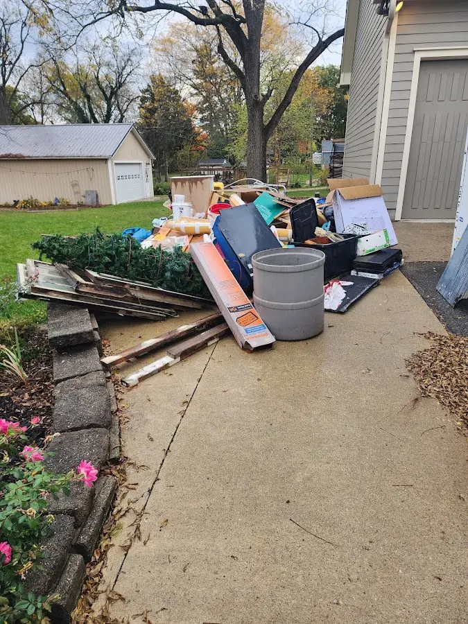 Dumpster being loaded with debris for Commercial Dumpster Rental in West Slope